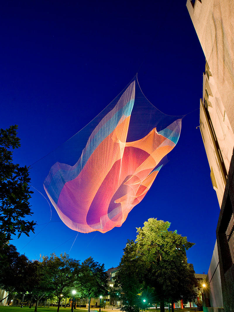 Illustration for article titled Artists creates awesome artificial glowing nebulae over city skies